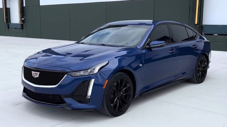A front-left 3/4 view of a blue 2021 Cadillac CT5 Sport