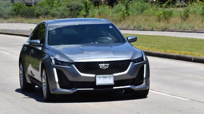 A silver 2021 Cadillac CT5 driving on the highway