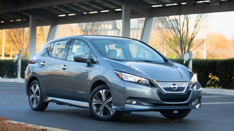 A gray 2021 Nissan Leaf at a charging station.