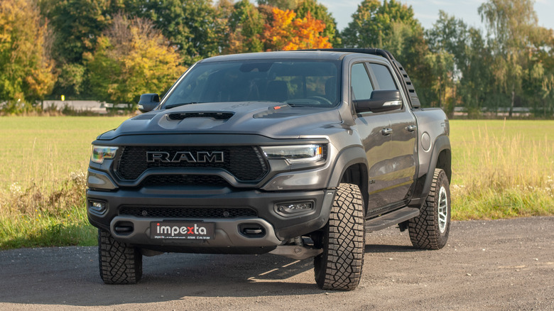A gray Ram 1500 shown in a parking lot.