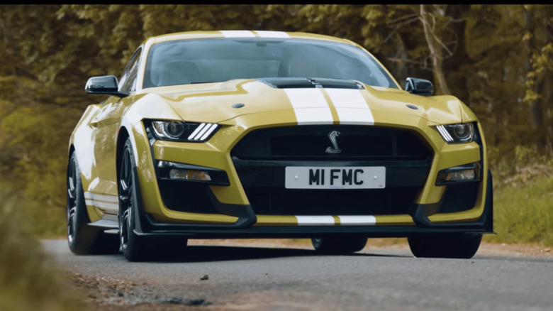 A yellow 2021 Ford Mustang Shelby GT500 on a road