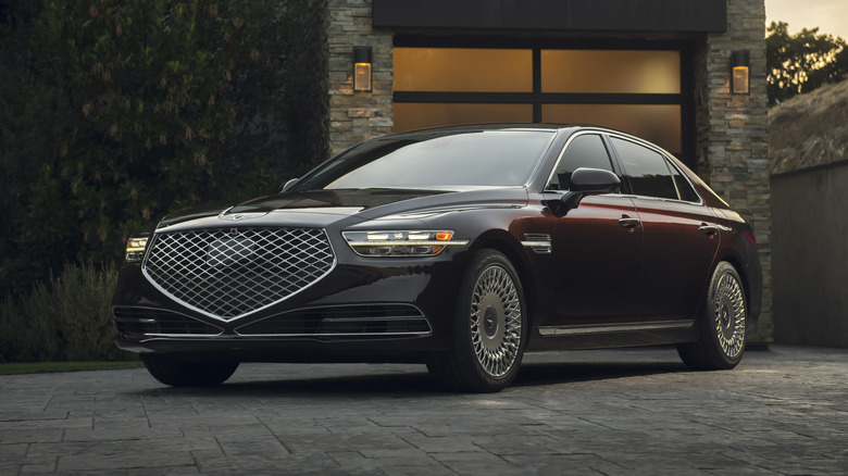 A brown 2021 Genesis G90 in front of a garage.
