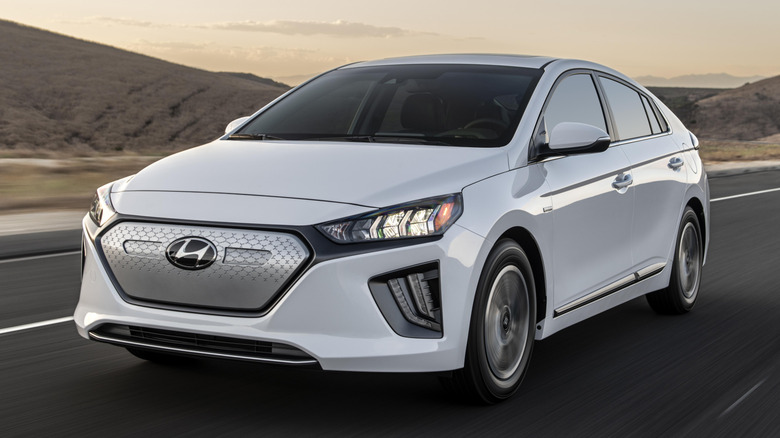 A white 2021 Hyundai Ioniq Electric on a highway.