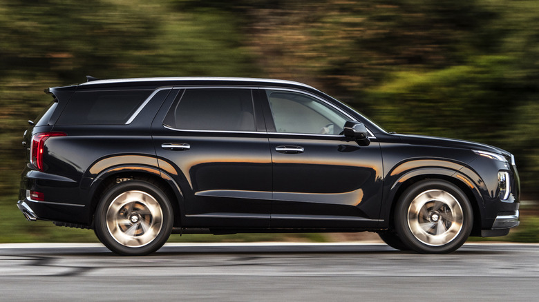 Right-side view of a black 2021 Hyundai Palisade on a highway