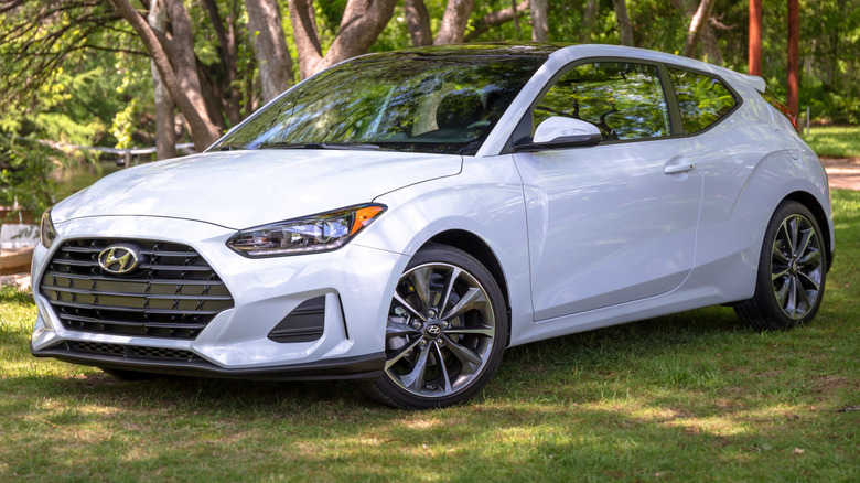 2021 Hyundai Veloster parked on a grass field with trees