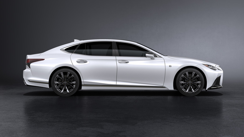 A side view of a white 2021 Lexus LS 500 in a studio environment