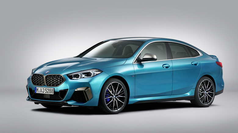 A blue BMW M235i xDrive with a plain background.