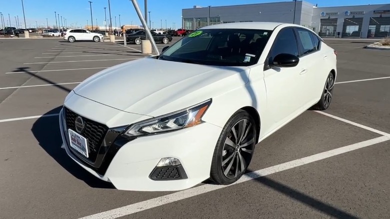 Driver's side view of a white 2021 Nissan Altima SR in a parking lot