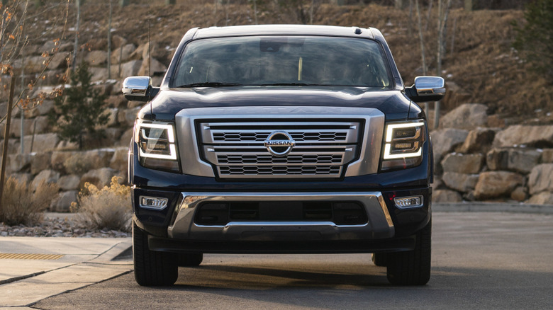 A front view of a blue 2021 Nissan Titan on pavement.