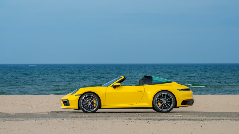 A yellow 2021 Porsche Targa on a beach