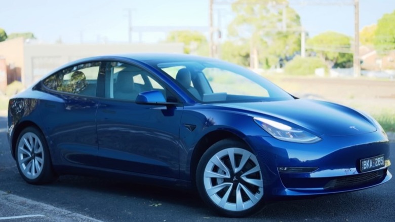 Blue 2021 Tesla Model 3 parked on a paved surface