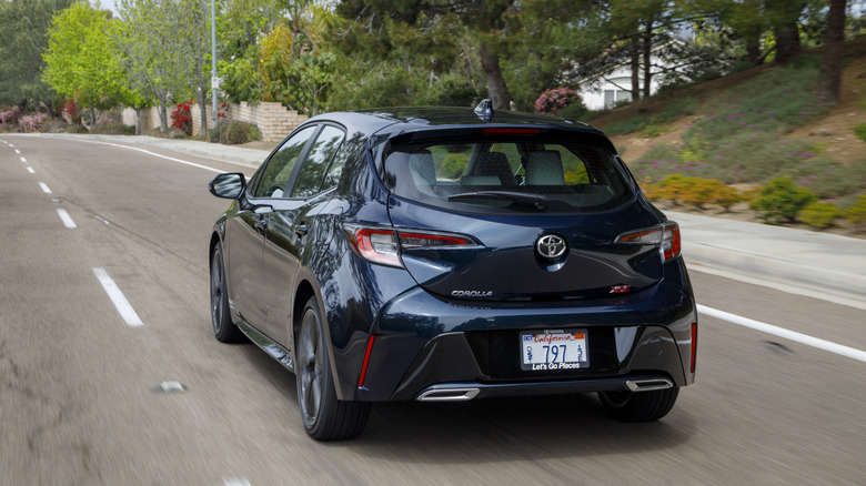A blue 2021 Toyota Corolla Hatchback on a street.