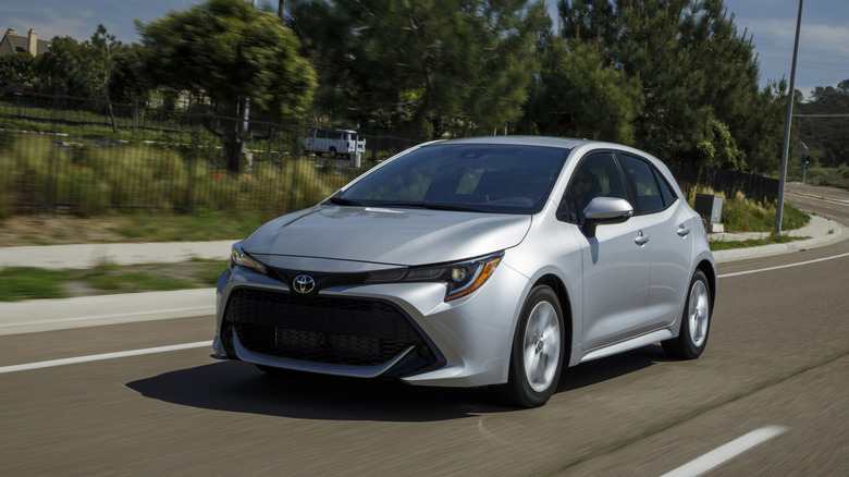 A silver 2021 Toyota Corolla Hatchback on a roadway.