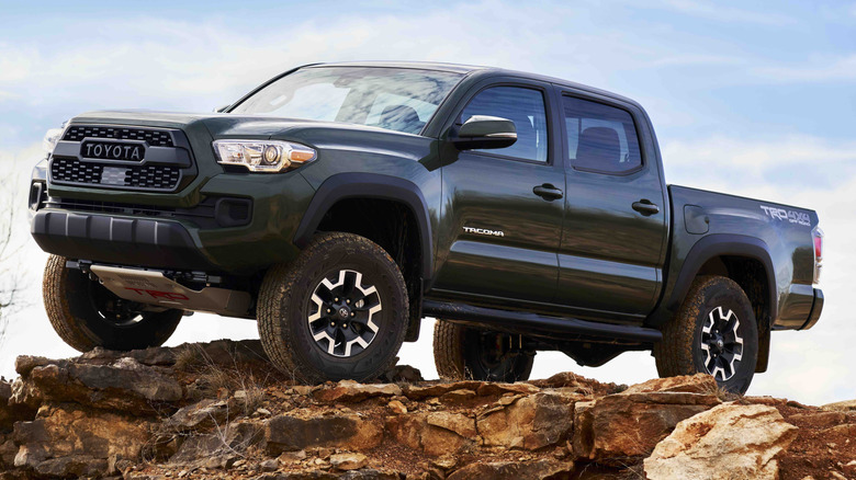 A black 2021 Toyota Tacoma TRD parked on a rocky cliff