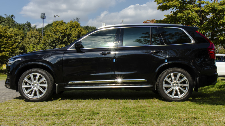 A side-profile shot of a 2021 black Volvo XC90 SUV.