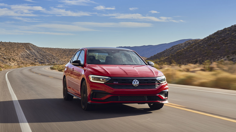 A red 2021 Volkswagen Jetta GLI on a desert highway.