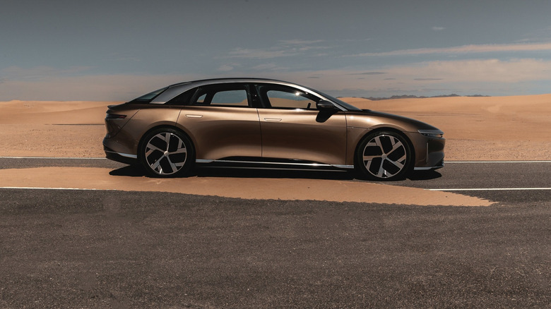 A brown Lucid Air parked on pavement.