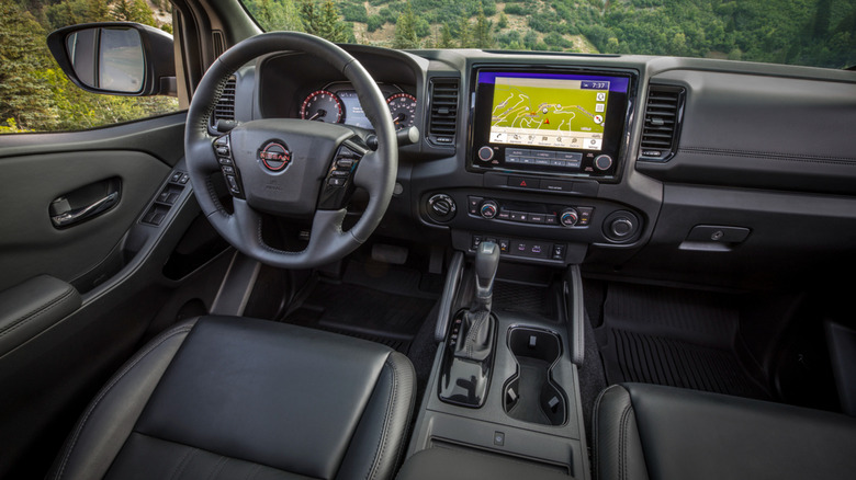An interior shot of a 2022 Nissan Frontier with a desert environment in the background