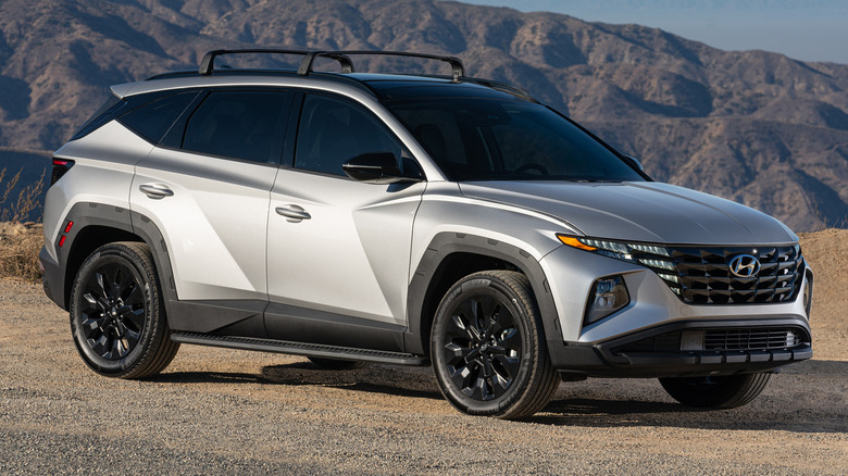 A 2023 Hyundai Tucson XRT parked in a rugged outdoor environment with mountains in the background