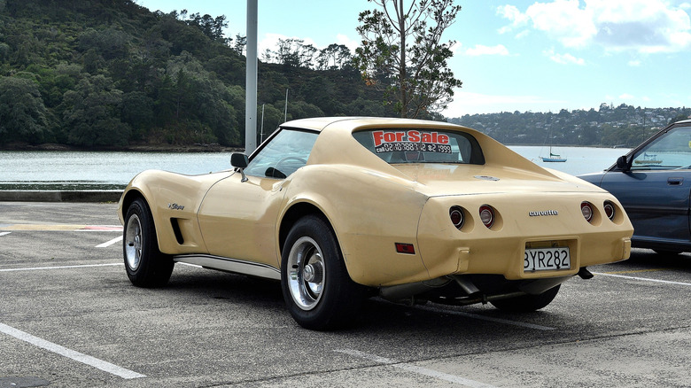 A rear-quarter view of a pale yellow '75 Corvette