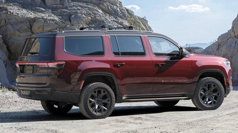 A maroon 2026 Jeep Grand Wagoneer parked near rocky hills