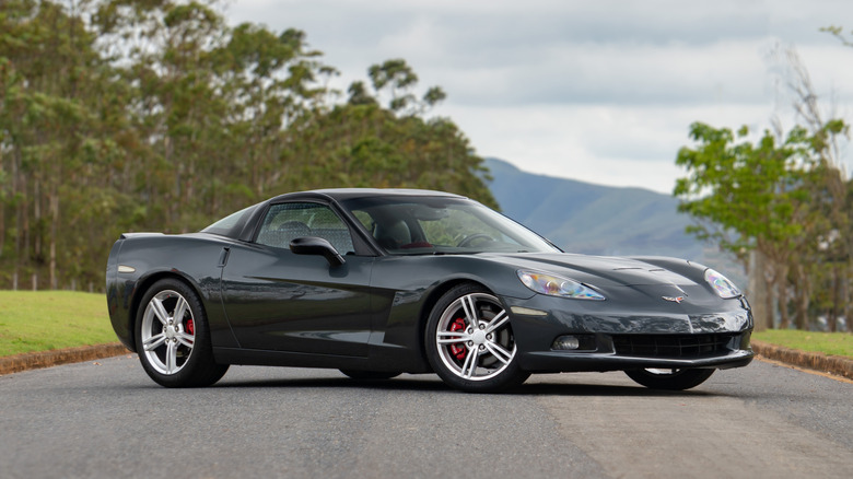 A dark gray Chevrolet C6 Corvette parked on a country road