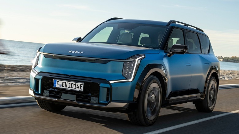 2024 Kia EV9 driving down a coastal highway
