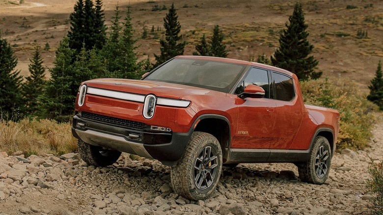 Rivian R1 driving up a rocky hill