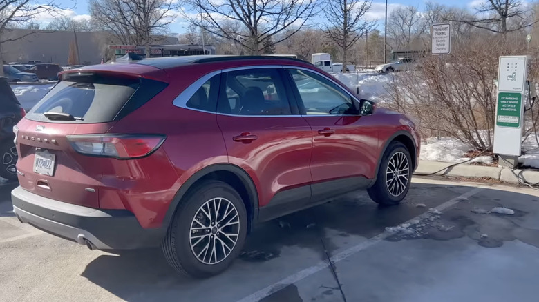 A red 2021 Ford Escape plug-in hybrid getting charged