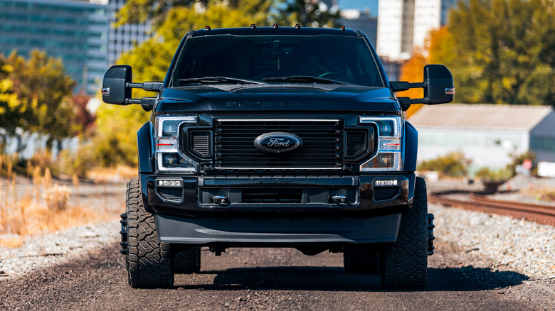 A front-end view of a massive black Ford F-450 Super Duty truck.