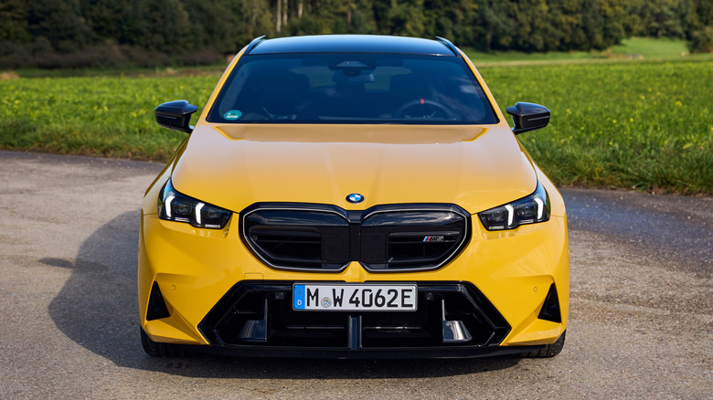 A front-end view of a yellow BMW M5.