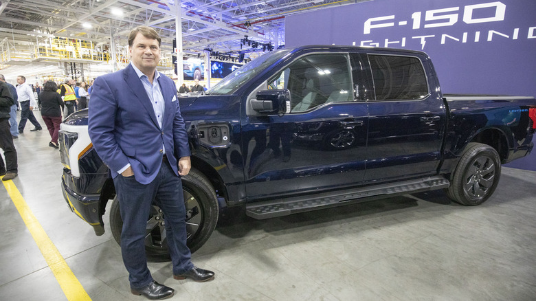Jim Farley poses for a photo with an all-electric F-150 Lightning pickup truck during the vehicle's launch at the Ford Rouge Electric Vehicle Center on April 26, 2022 in Dearborn, Michigan
