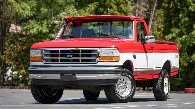 Front shot of a red and white square body Ford F-150 XLT