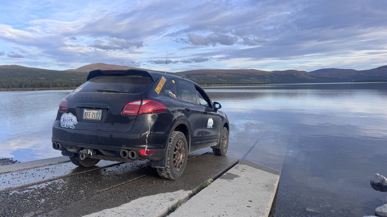 Porsche Cayenne parked on the edge of the water