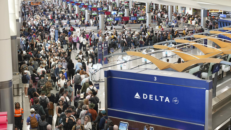 view of the atlanta airport of people backed up at the TSA line.