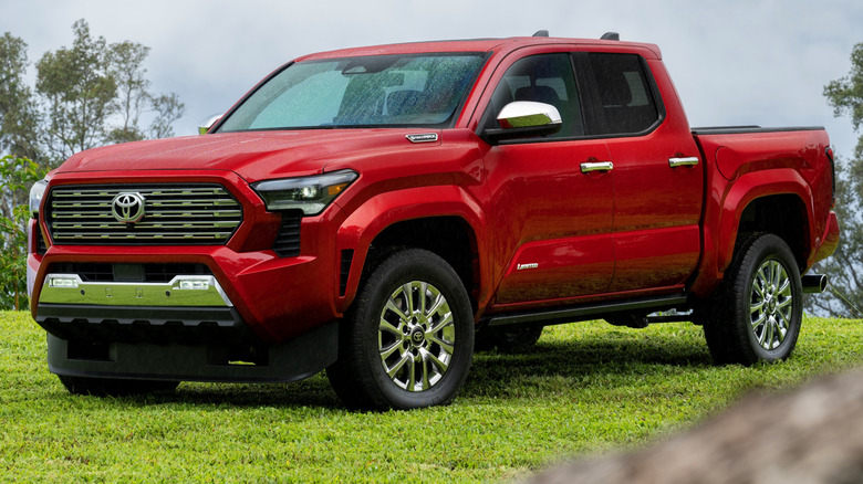Red 2026 Toyota Tacoma Limited parked on lush green grass