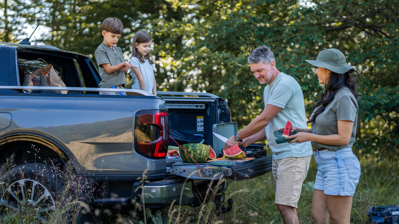 A family having a picnic on their tailgate