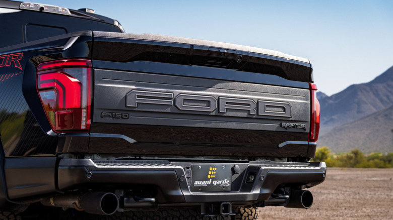 Tailgate of a black Ford Raptor shown up close.