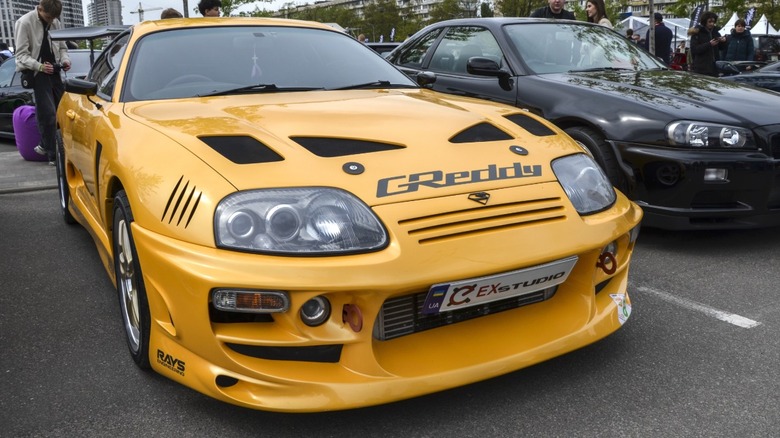 Yellow Toyota Supra A80 parked at a car meet