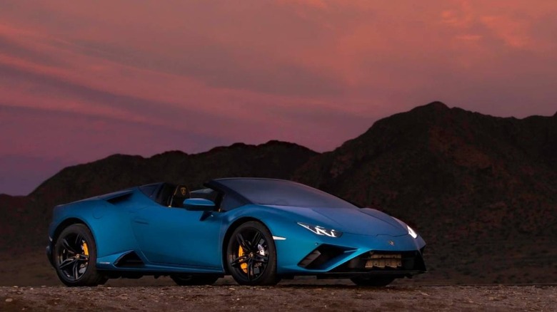 Blue Lamborghini Huracan Evo in front of mountains at sunset