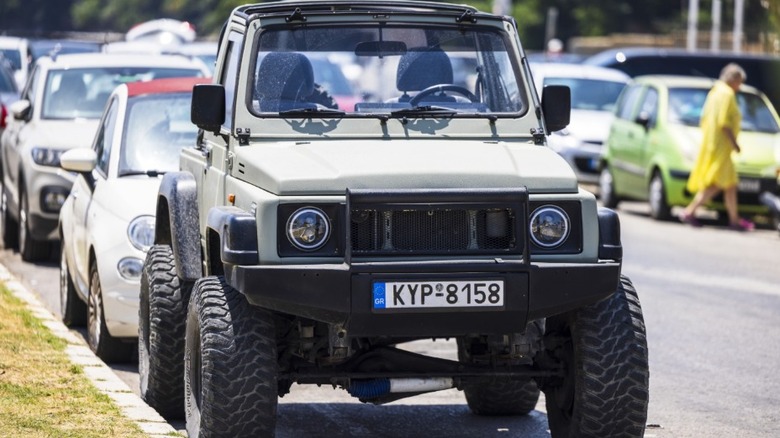 A Suzuki Samurai with lifted suspension and off-road tires