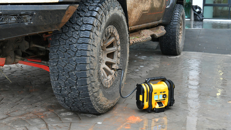 A small electric pump inflates an off-road vehicle tire