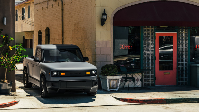 A slate driving truck in a town.