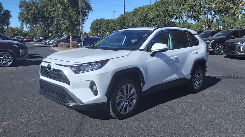 A white 2019 Toyota RAV4 XLE Premium in a dealership lot