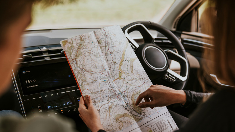 Driver looking at map in car photo