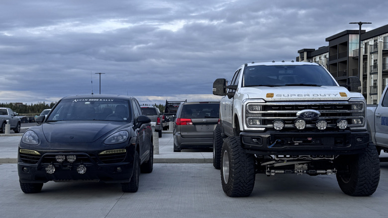 Lifted Super Duty next to a Porsche Cayenne