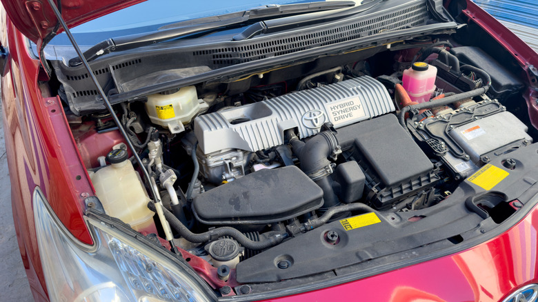 Under the hood of a red Toyota Prius hybrid car