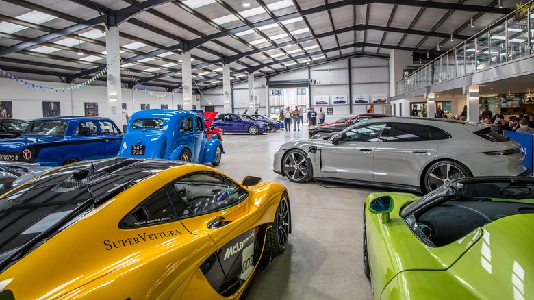 An indoor industrial-looking supercar and classic car storage unit.