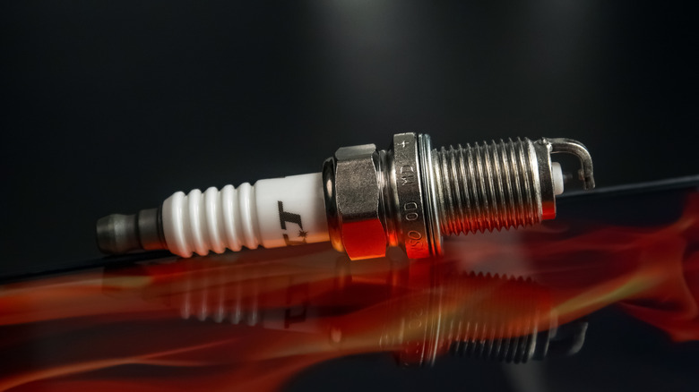 Denso Iridium TT spark plug connected apical of a car's hood