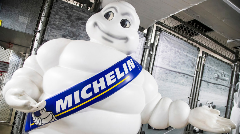 The Michelin man pointing to product in a storage space